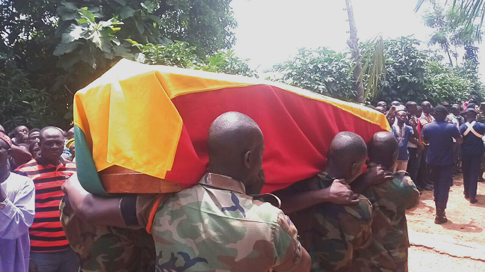   The casket containing the remains of Dr David Abdulai being carried by military pallbearers. INSET: Dr David Abdulai.